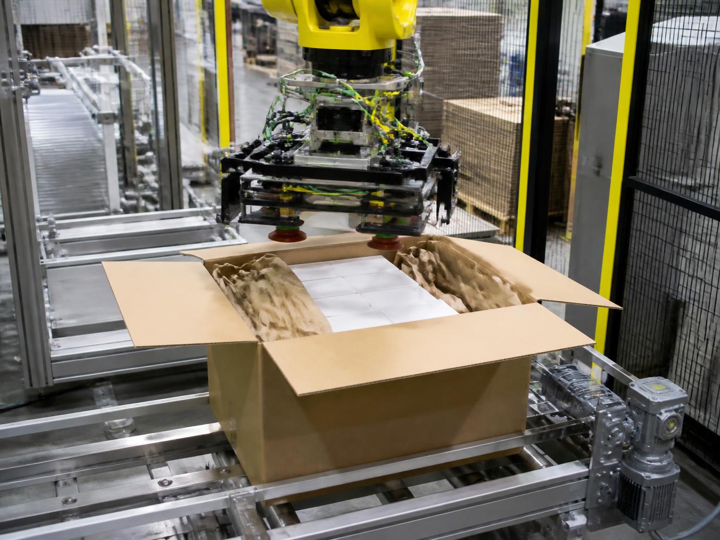 Automated case packing station loading products into a corrugated case with protective void fill